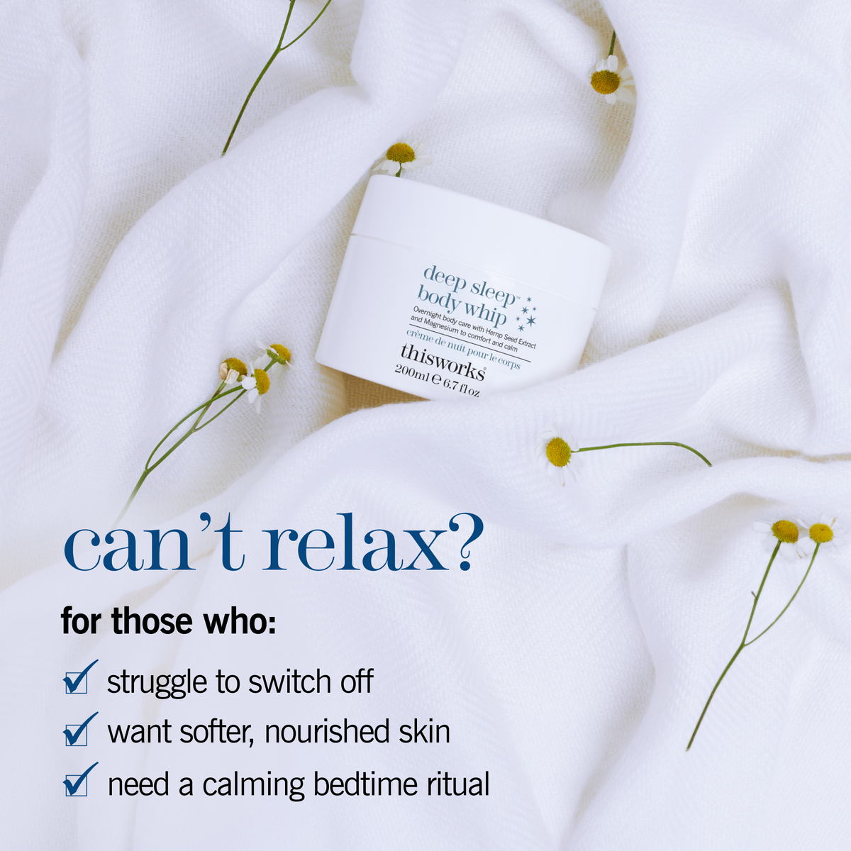 A white jar of thisworks Deep Sleep Body Whip body butter rests on soft white textured fabric with small yellow flowers scattered around it. Blue promotional text on the left reads, 'can’t relax? for those who: struggle to switch off, want softer, nourished skin, need a calming bedtime ritual.